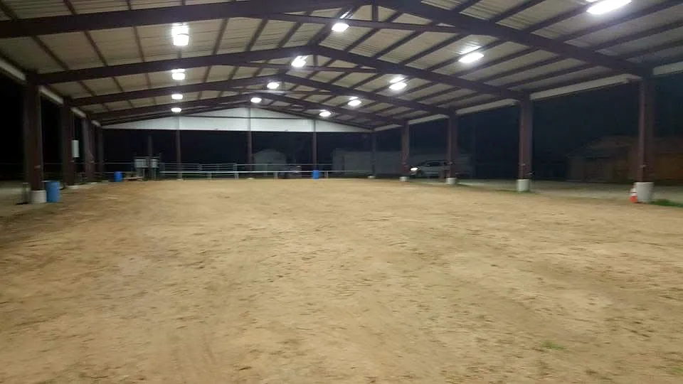 Covered arena lit by new LED high-bay fixtures at night