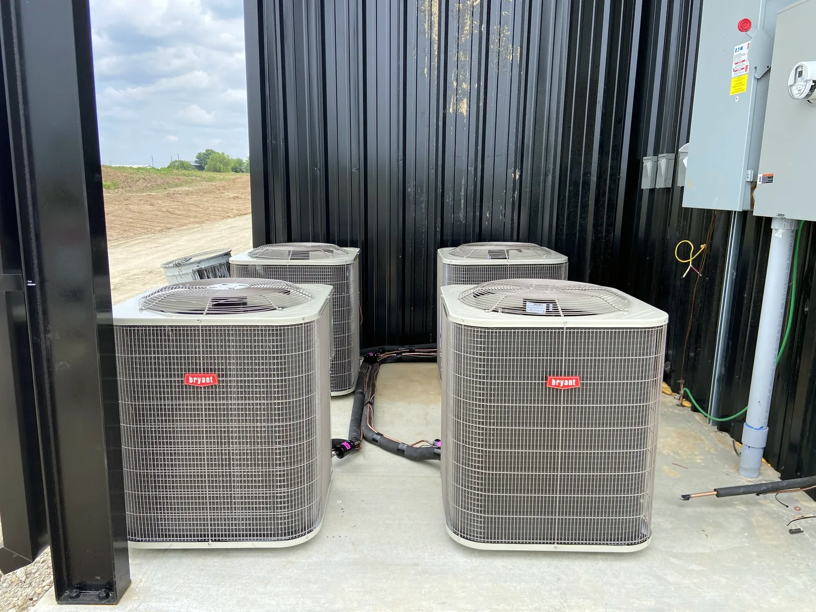 Bryant condensing units with new line sets next to the building's electrical service